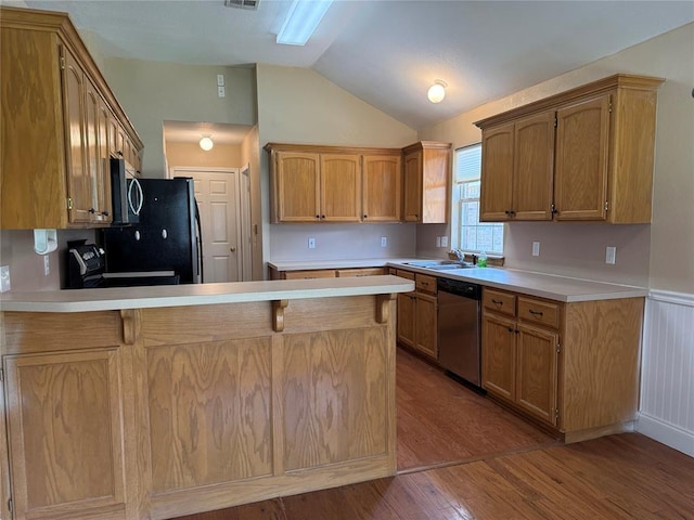 1617 Briarcreek, Norman, OK 73071 - kitchen with black appliances, vaulted ceiling, a peninsula, wood finished floors, and a sink