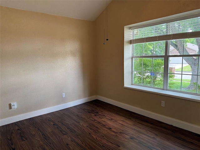 1617 Briarcreek, Norman, OK 73071 - empty room featuring baseboards, dark wood-style floors, and vaulted ceiling