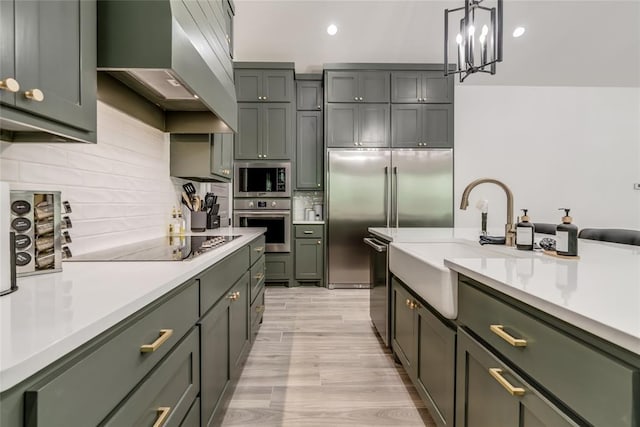 118289 S 4215th Rd, Eufaula, OK 74432 - kitchen with stainless steel appliances, wall chimney range hood, a sink, light countertops, and recessed lighting