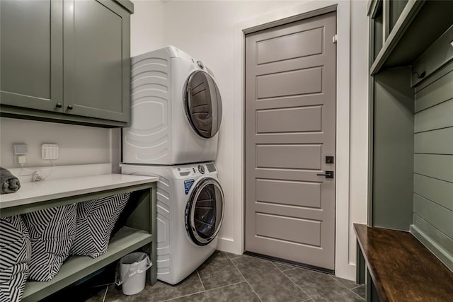 118289 S 4215th Rd, Eufaula, OK 74432 - laundry room featuring stacked washer / drying machine, cabinet space, and dark tile patterned flooring