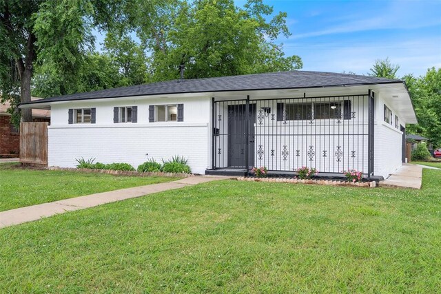 444 NW 86th St, Oklahoma City, OK 73114 - ranch-style home featuring brick siding, a front yard, and roof with shingles