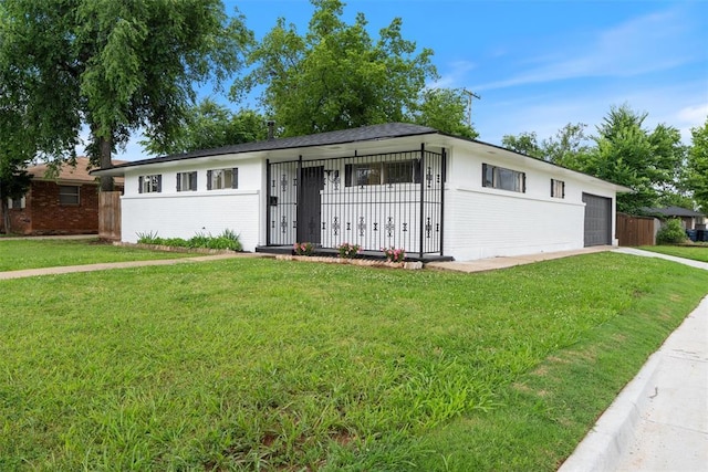 444 NW 86th St, Oklahoma City, OK 73114 - ranch-style home featuring a front lawn, concrete driveway, brick siding, and an attached garage