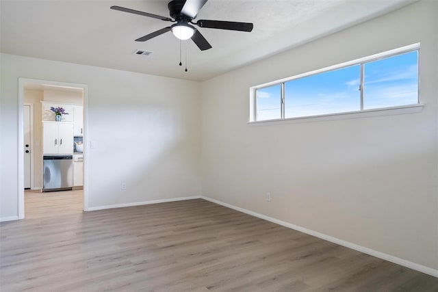 444 NW 86th St, Oklahoma City, OK 73114 - empty room featuring light wood finished floors, baseboards, a ceiling fan, and washer / dryer