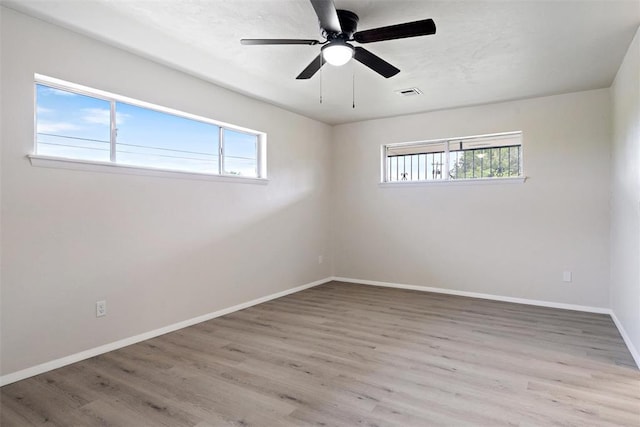 444 NW 86th St, Oklahoma City, OK 73114 - spare room with healthy amount of natural light, wood finished floors, baseboards, and a ceiling fan