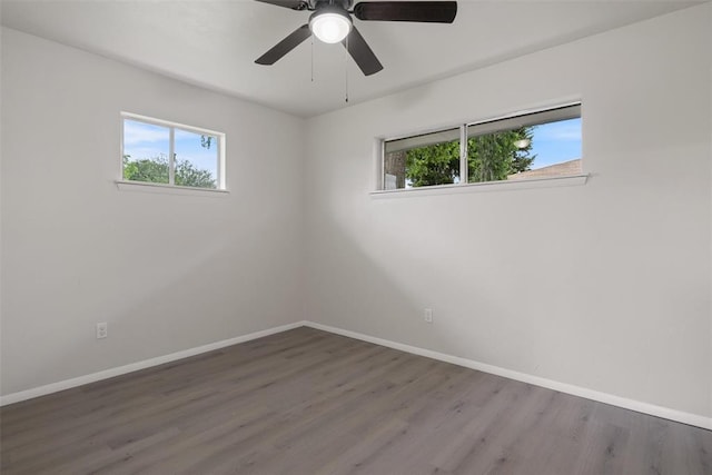 444 NW 86th St, Oklahoma City, OK 73114 - unfurnished room featuring healthy amount of natural light, wood finished floors, and baseboards
