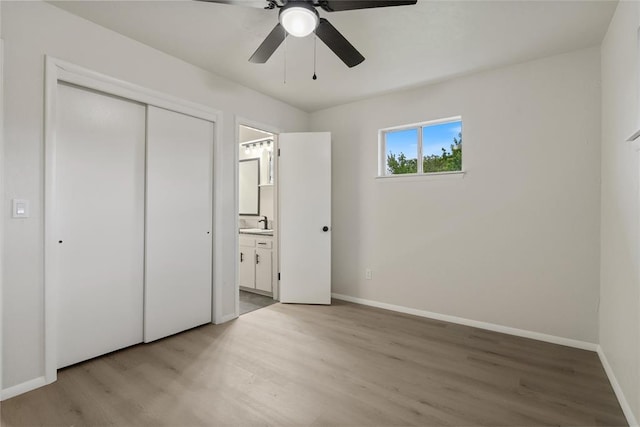 444 NW 86th St, Oklahoma City, OK 73114 - unfurnished bedroom featuring light wood finished floors, baseboards, a closet, and ensuite bathroom