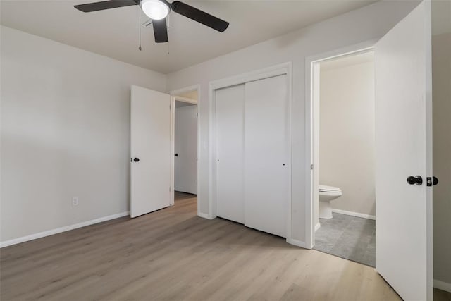 444 NW 86th St, Oklahoma City, OK 73114 - unfurnished bedroom featuring wood finished floors, baseboards, a closet, and ensuite bathroom