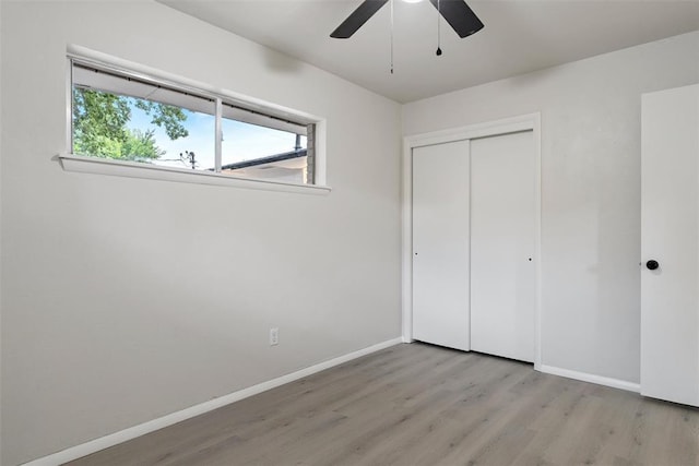 444 NW 86th St, Oklahoma City, OK 73114 - unfurnished bedroom with wood finished floors, baseboards, a closet, and a ceiling fan