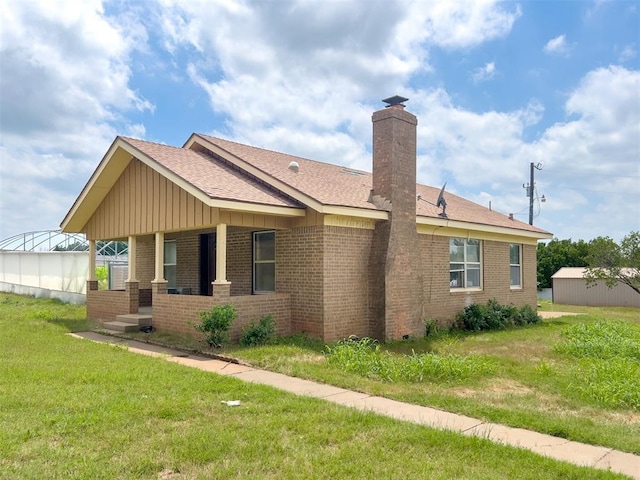 8701 Cornforth Rd, Guthrie, OK 73044 - view of front of property with brick siding, a chimney, a front yard, and a shingled roof