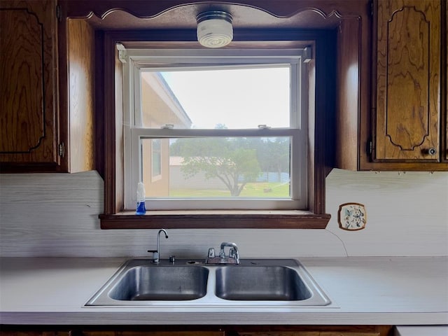 8701 Cornforth Rd, Guthrie, OK 73044 - kitchen featuring a sink, light countertops, and backsplash
