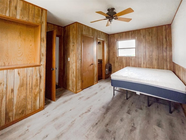 8701 Cornforth Rd, Guthrie, OK 73044 - bedroom featuring wood walls, light wood-type flooring, and a ceiling fan