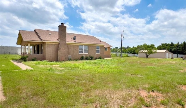 8701 Cornforth Rd, Guthrie, OK 73044 - back of house with a lawn, a chimney, and brick siding