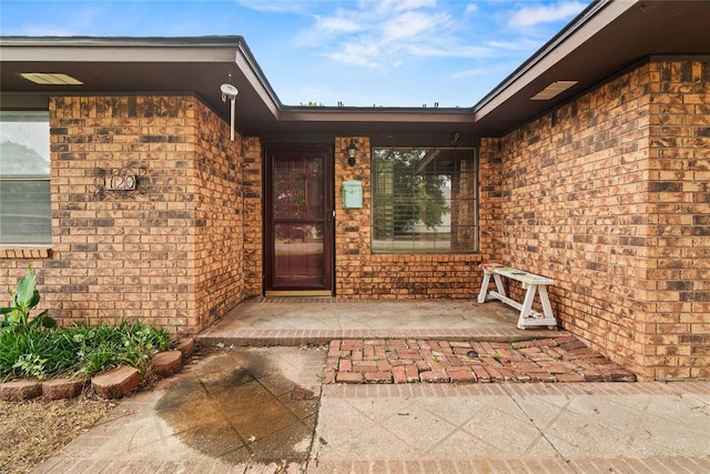 720 W 3rd St, Watonga, OK 73772 - view of exterior entry featuring brick siding