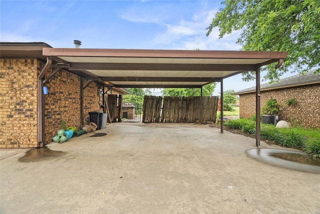 720 W 3rd St, Watonga, OK 73772 - view of vehicle parking featuring a carport, a gate, and concrete driveway