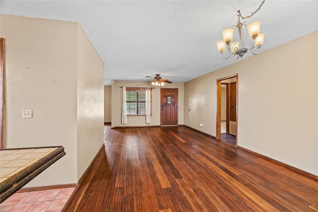 720 W 3rd St, Watonga, OK 73772 - unfurnished living room with a chandelier, a ceiling fan, wood finished floors, and baseboards