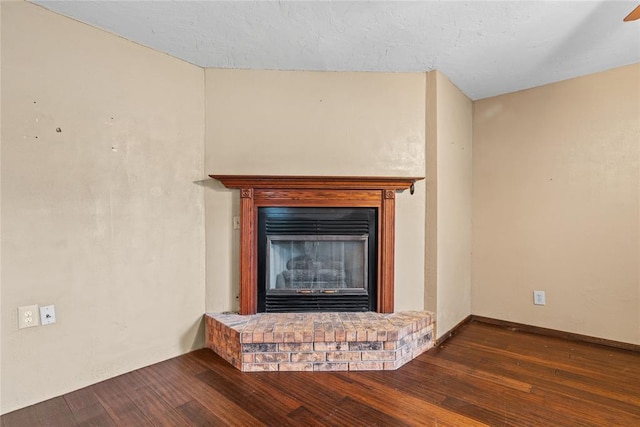 720 W 3rd St, Watonga, OK 73772 - detailed view of wood finished floors and a brick fireplace