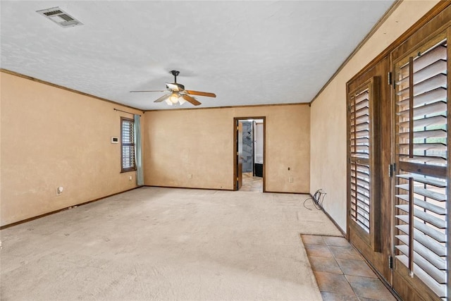 720 W 3rd St, Watonga, OK 73772 - empty room with a ceiling fan, ornamental molding, carpet floors, and baseboards