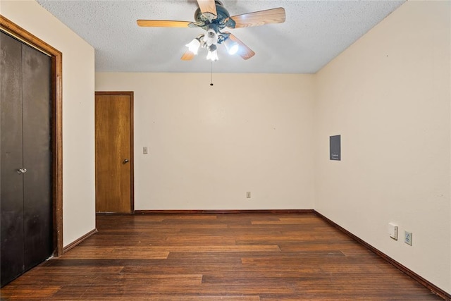 720 W 3rd St, Watonga, OK 73772 - empty room featuring ceiling fan, a textured ceiling, wood finished floors, and baseboards