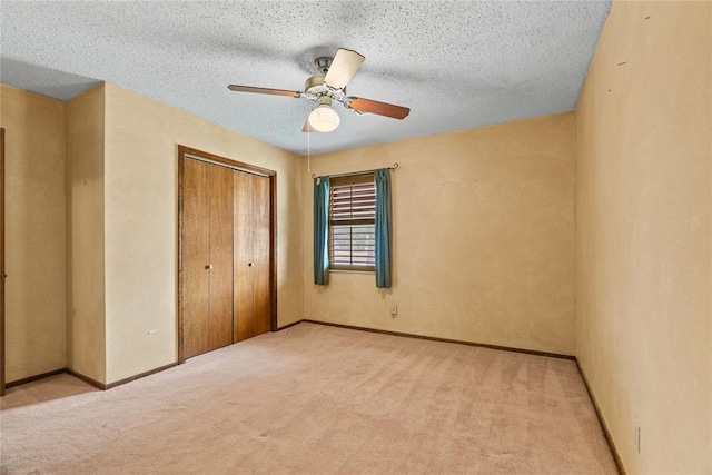 720 W 3rd St, Watonga, OK 73772 - unfurnished bedroom with a closet, light colored carpet, ceiling fan, and a textured ceiling