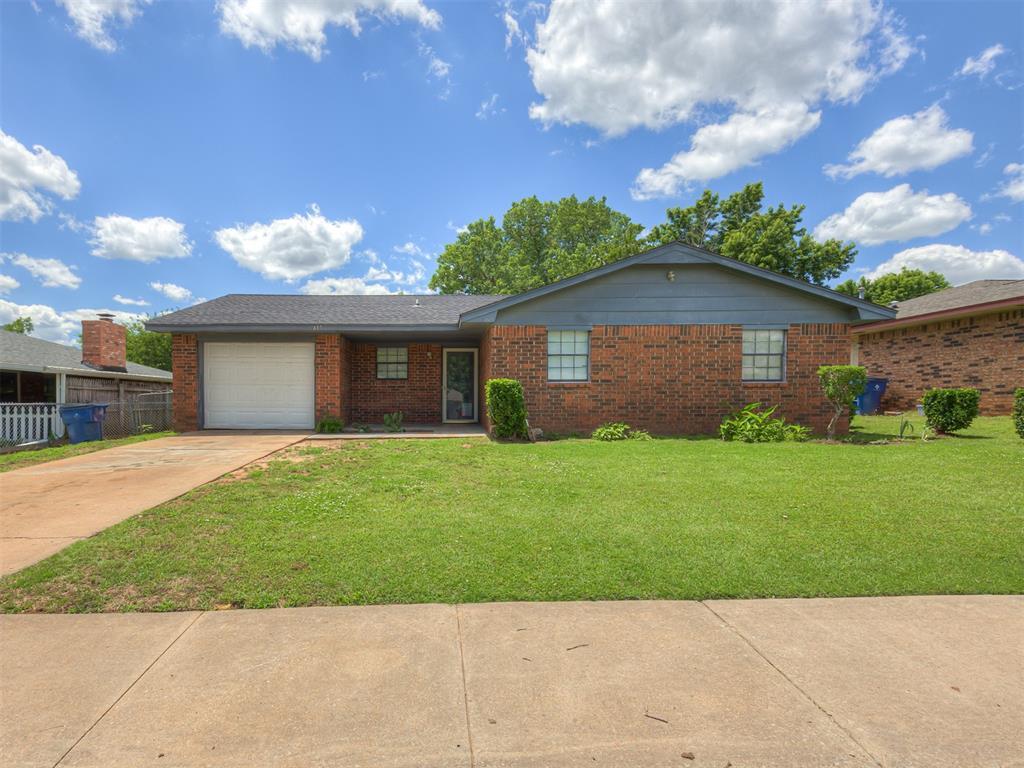 417 Milky Way, Guthrie, OK 73044 - ranch-style home featuring a garage, brick siding, and driveway