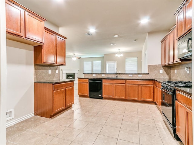 9708 Squire Ln, Yukon, OK 73099 - kitchen with black appliances, a peninsula, decorative backsplash, brown cabinetry, and ceiling fan