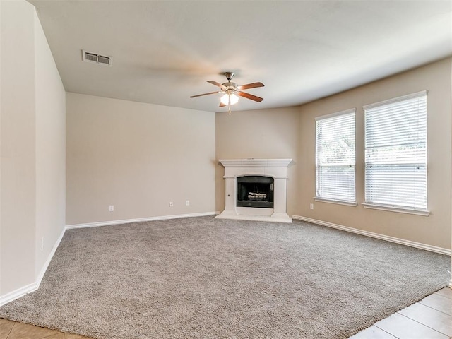 9708 Squire Ln, Yukon, OK 73099 - unfurnished living room with ceiling fan, carpet floors, and a fireplace with raised hearth