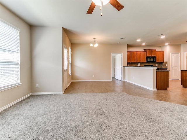 9708 Squire Ln, Yukon, OK 73099 - unfurnished living room with healthy amount of natural light, a chandelier, light tile patterned floors, ceiling fan, and recessed lighting
