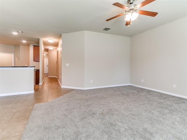 9708 Squire Ln, Yukon, OK 73099 - unfurnished room with a ceiling fan, light tile patterned floors, and light colored carpet