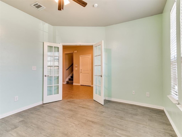 9708 Squire Ln, Yukon, OK 73099 - empty room featuring french doors, a ceiling fan, wood finished floors, and stairs