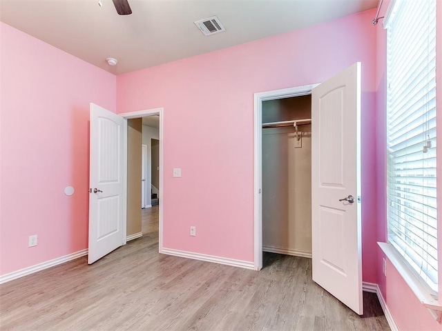 9708 Squire Ln, Yukon, OK 73099 - unfurnished bedroom featuring light wood-style flooring, a closet, and a ceiling fan