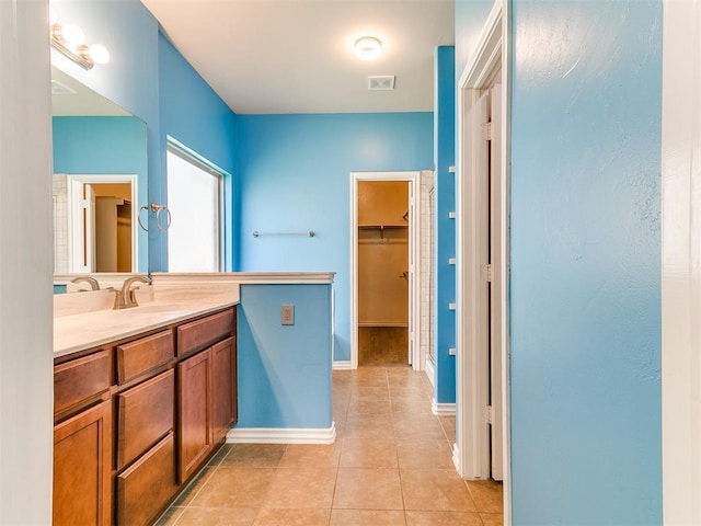 9708 Squire Ln, Yukon, OK 73099 - bathroom with vanity, tile patterned floors, and a spacious closet