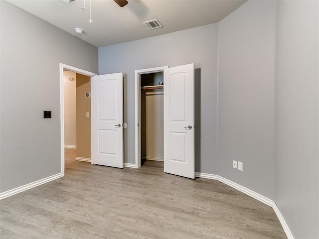 9708 Squire Ln, Yukon, OK 73099 - unfurnished bedroom with light wood-style floors, a closet, and ceiling fan