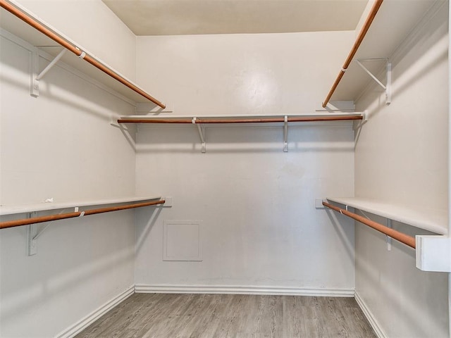 9708 Squire Ln, Yukon, OK 73099 - spacious closet featuring wood finished floors