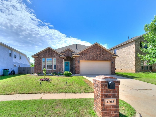 9708 Squire Ln, Yukon, OK 73099 - view of front of home with driveway, an attached garage, and brick siding