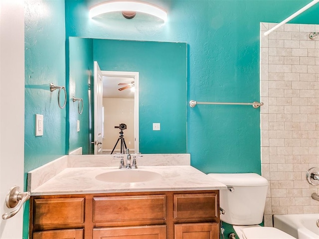 9708 Squire Ln, Yukon, OK 73099 - bathroom featuring vanity, tub / shower combination, and a textured wall