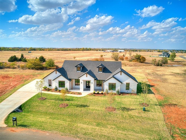 13133 Ashlyn Ln, Yukon, OK 73099 - modern inspired farmhouse with a front yard, concrete driveway, and a view of countryside
