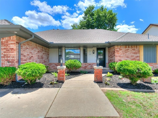 7420 NW 104th St, Oklahoma City, OK 73162 - view of front facade with brick siding, a porch, and roof with shingles