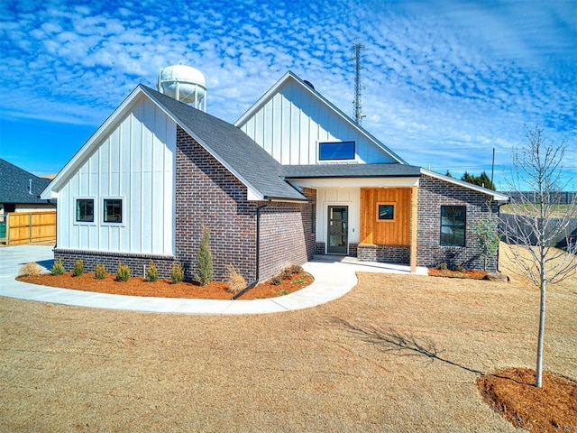9608 Sultans Water Way, Yukon, OK 73099 - modern farmhouse style home featuring board and batten siding, brick siding, and a shingled roof