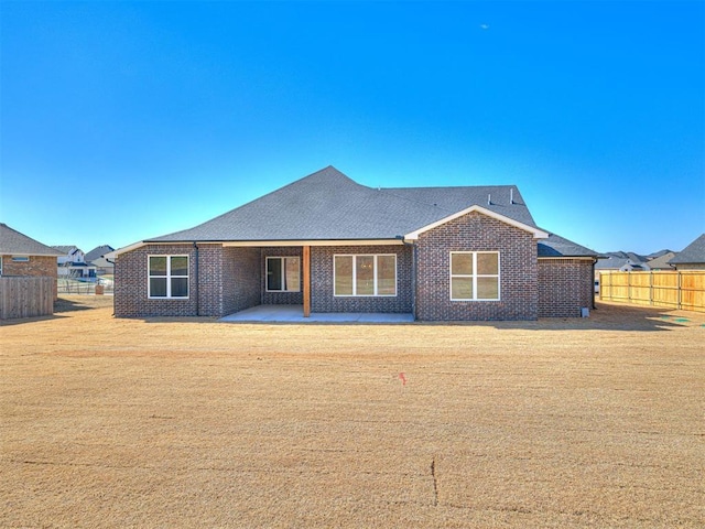9608 Sultans Water Way, Yukon, OK 73099 - back of property featuring brick siding, a patio, and a shingled roof