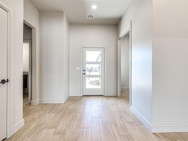 9608 Sultans Water Way, Yukon, OK 73099 - doorway featuring light wood-style flooring and baseboards