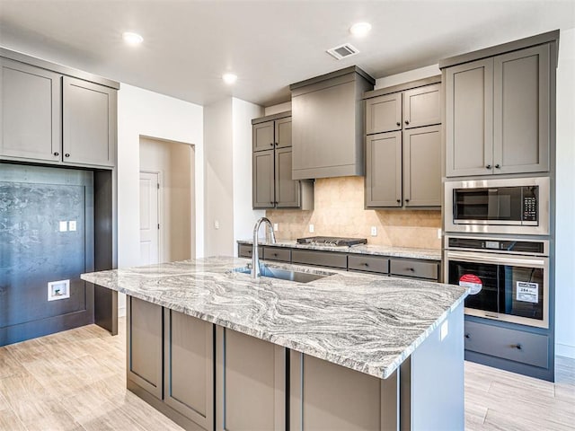 9608 Sultans Water Way, Yukon, OK 73099 - kitchen featuring appliances with stainless steel finishes, gray cabinets, a sink, light stone countertops, and recessed lighting