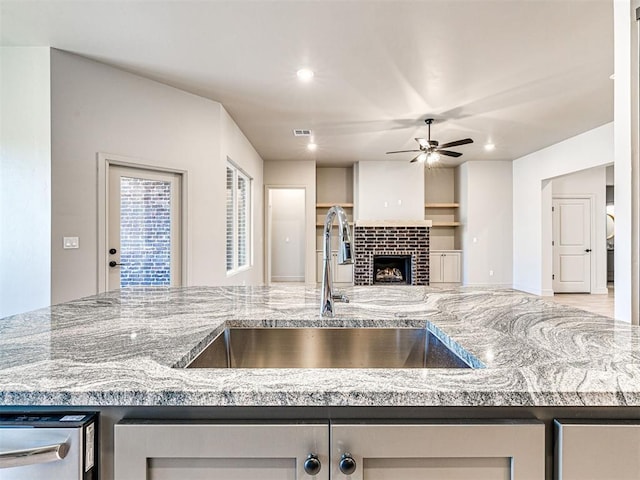 9608 Sultans Water Way, Yukon, OK 73099 - kitchen with a sink, ceiling fan, open floor plan, recessed lighting, and a fireplace