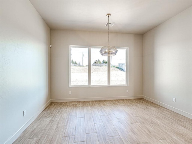 9608 Sultans Water Way, Yukon, OK 73099 - empty room featuring a chandelier, light wood-style flooring, and baseboards