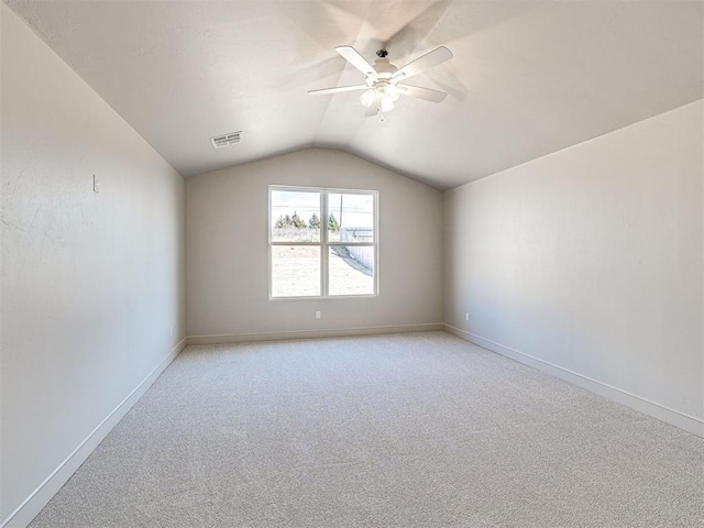 9608 Sultans Water Way, Yukon, OK 73099 - spare room with a ceiling fan, vaulted ceiling, light colored carpet, and baseboards