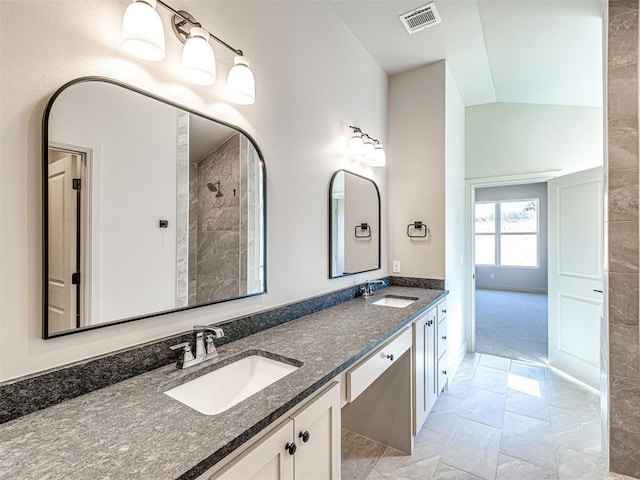 9608 Sultans Water Way, Yukon, OK 73099 - full bath with double vanity, marble look tiles, a tile shower, and baseboards