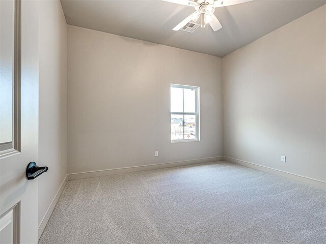 9608 Sultans Water Way, Yukon, OK 73099 - spare room featuring light carpet, ceiling fan, and baseboards