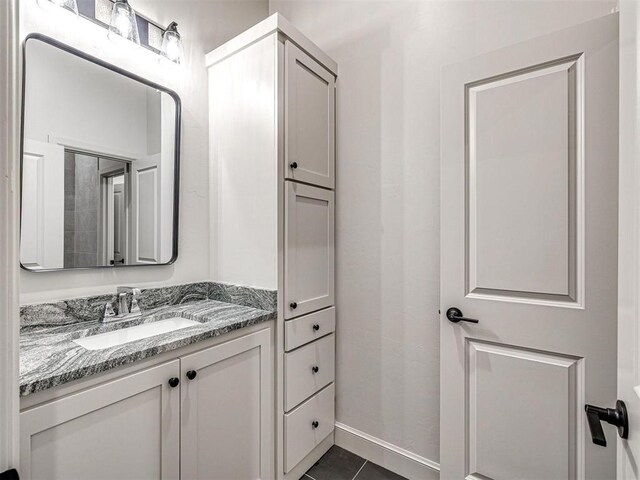 9608 Sultans Water Way, Yukon, OK 73099 - bathroom with vanity, tile patterned floors, and baseboards