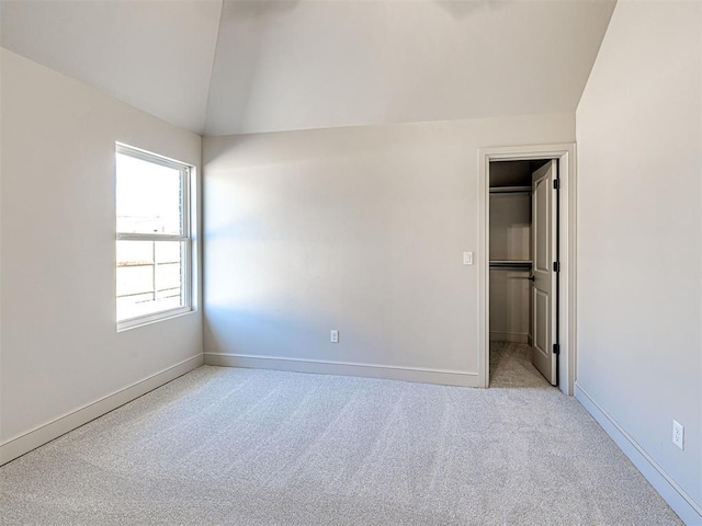 9608 Sultans Water Way, Yukon, OK 73099 - unfurnished bedroom with lofted ceiling, carpet floors, a spacious closet, and baseboards