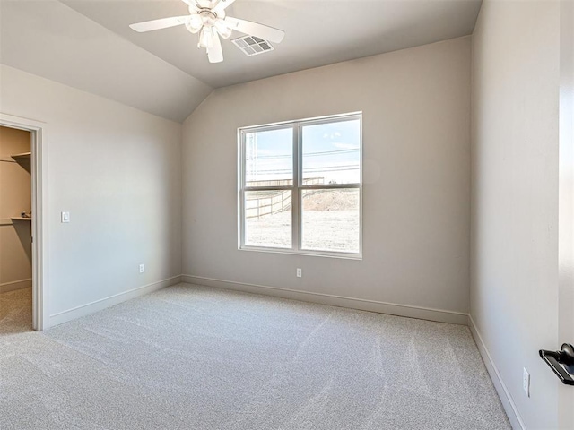 9608 Sultans Water Way, Yukon, OK 73099 - unfurnished bedroom featuring light carpet, a spacious closet, baseboards, vaulted ceiling, and a ceiling fan