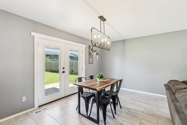 7921 NW 40th St, Bethany, OK 73008 - dining space with french doors, baseboards, and a chandelier